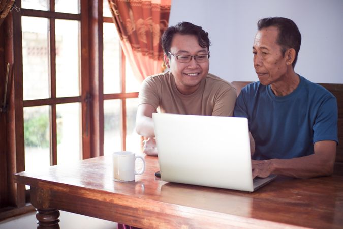 Father and son with laptop