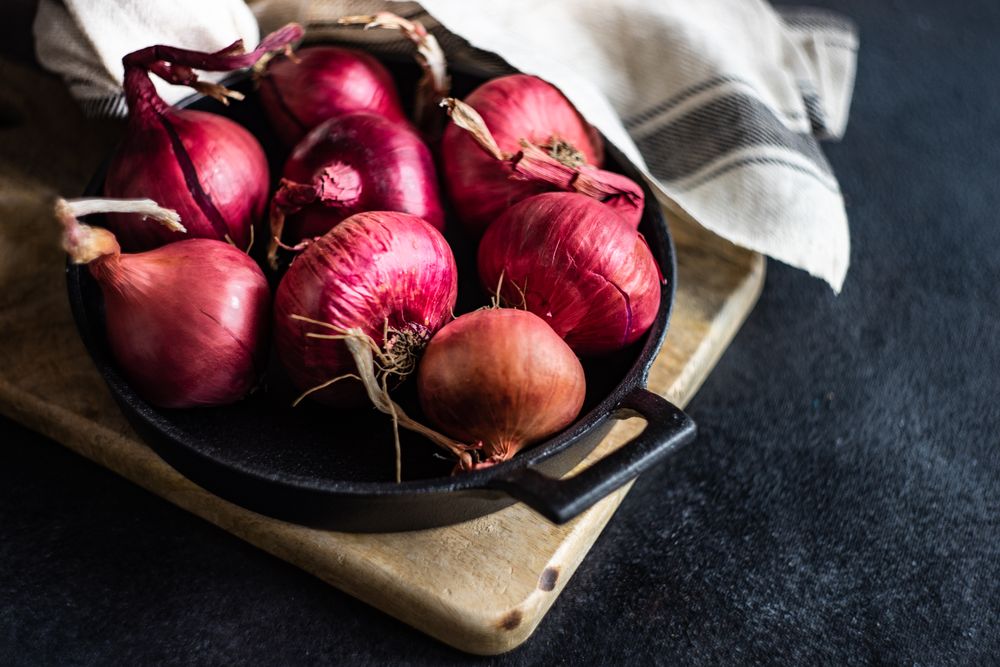Fresh raw red onions peppers in a pan
