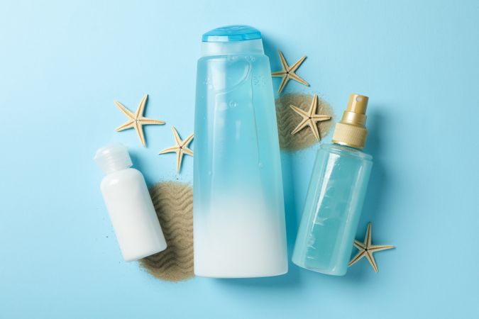 Composition of personal hygiene with bottles of cosmetics on blue background