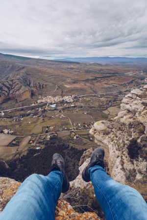 Tourist resting on edge of cliff