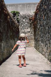 Girl in narrow stone walkway
