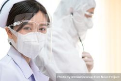 Female Asian nurse in protective mask and face shield in hospital 0JZAd0