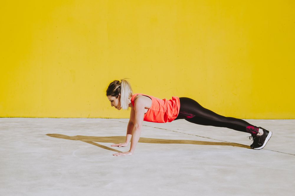 Woman doing plank exercises on floor