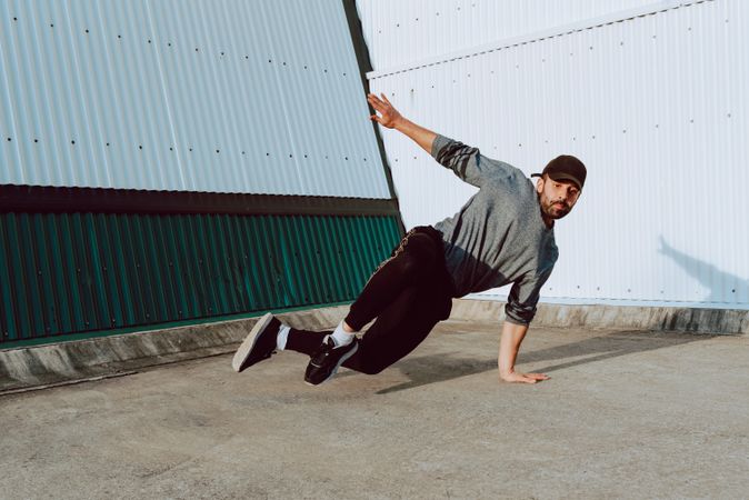 Man performing handstand near wall