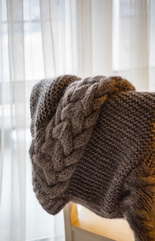Vintage knitting sweeter on a chair in light room