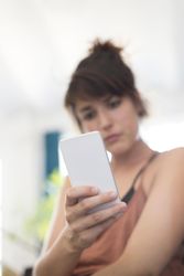Serious woman reading something on phone