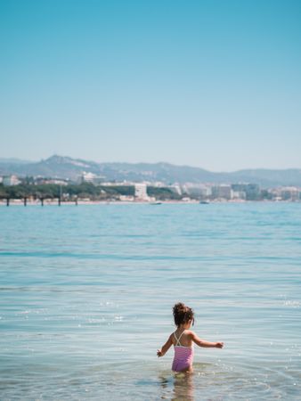 Cheerful girl having fun in warm sea