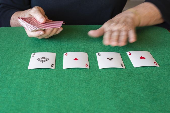 Person playing cards with aces