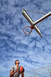 Basketball player preparing to throw ball into ring