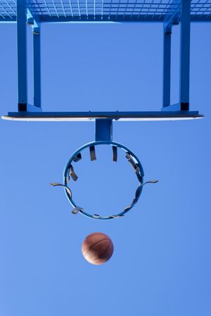 Image of a ball going towards a basketball hoop
