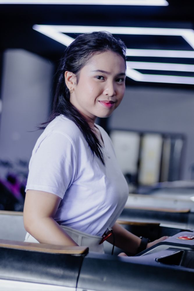 Confident woman exercising on treadmill at modern fitness center