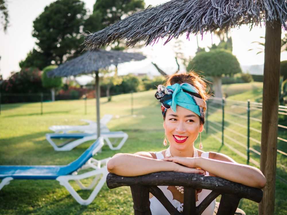 Young elegant Chinese woman sunbathing