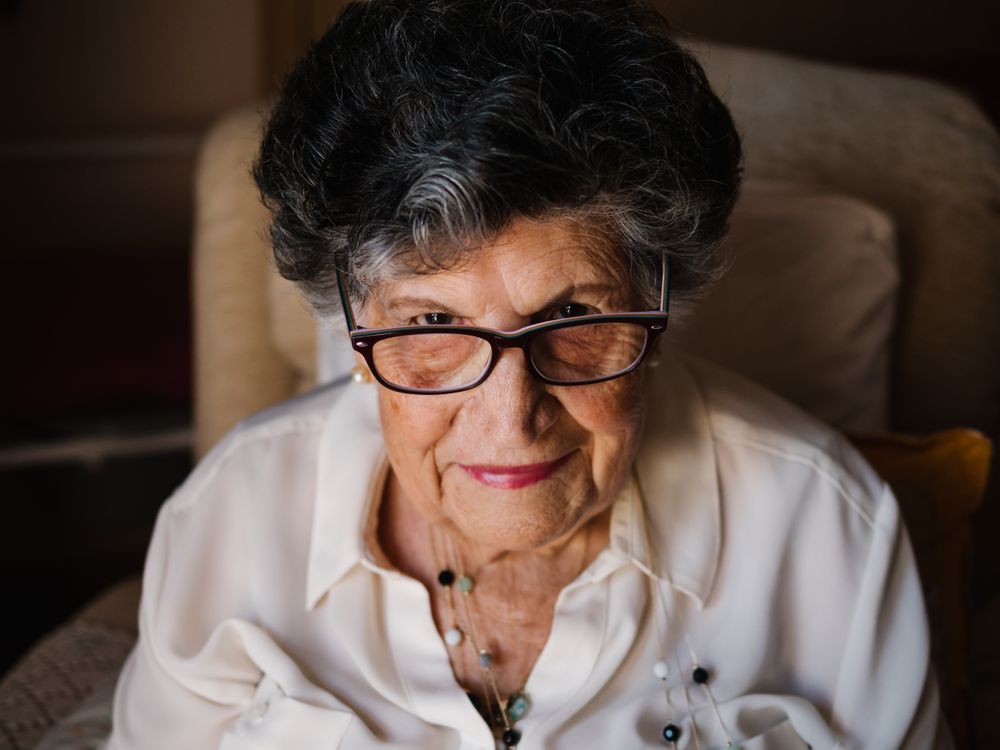 Portrait of older female in white shirt at home
