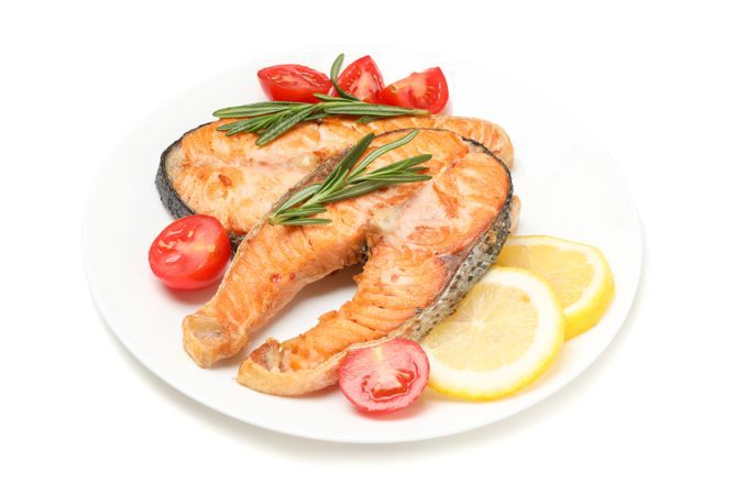 Plate with grilled salmon isolated on blank background