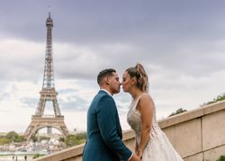 Happy newlyweds in wedding clothing kissing