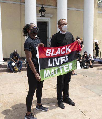 Priest and woman holding a Black Lives Matter sign, Washington, D.C.
