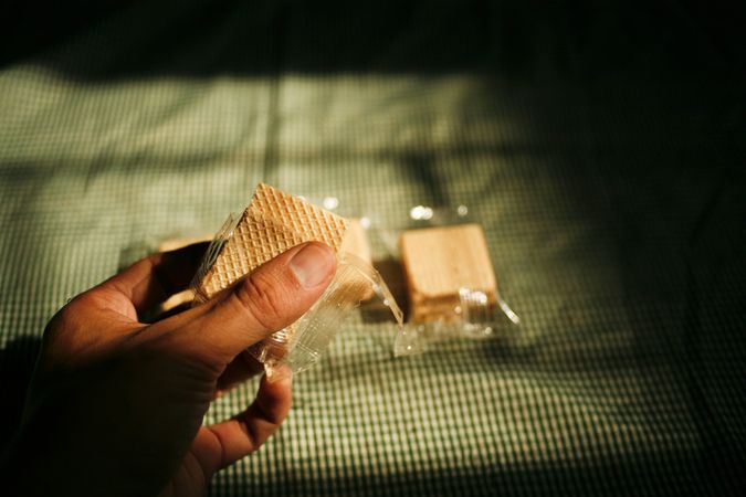 Hand reaching for wafer