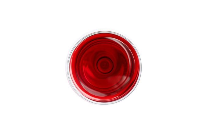 Glass with red wine isolated on blank background, top view