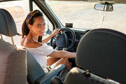 Happy woman driving camper car