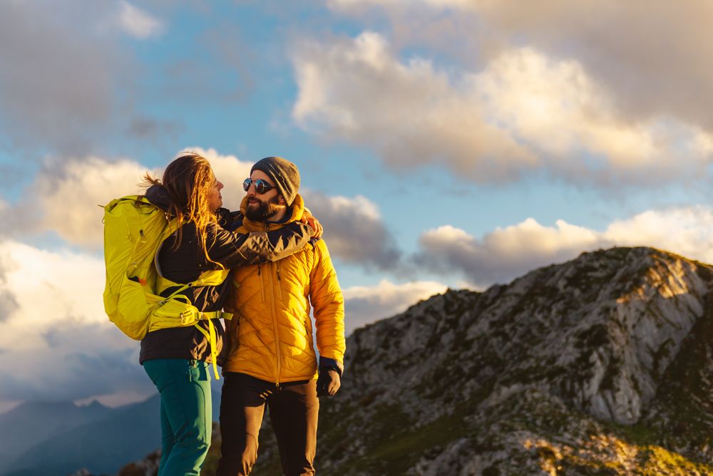man and woman hiking in the mountains
