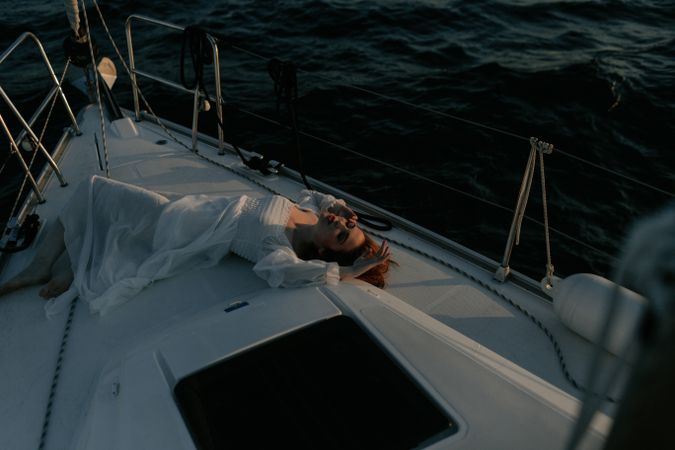 Woman in luxury dress resting on yacht