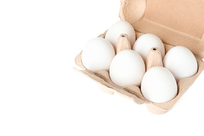 chicken eggs in carton box isolated on blank background