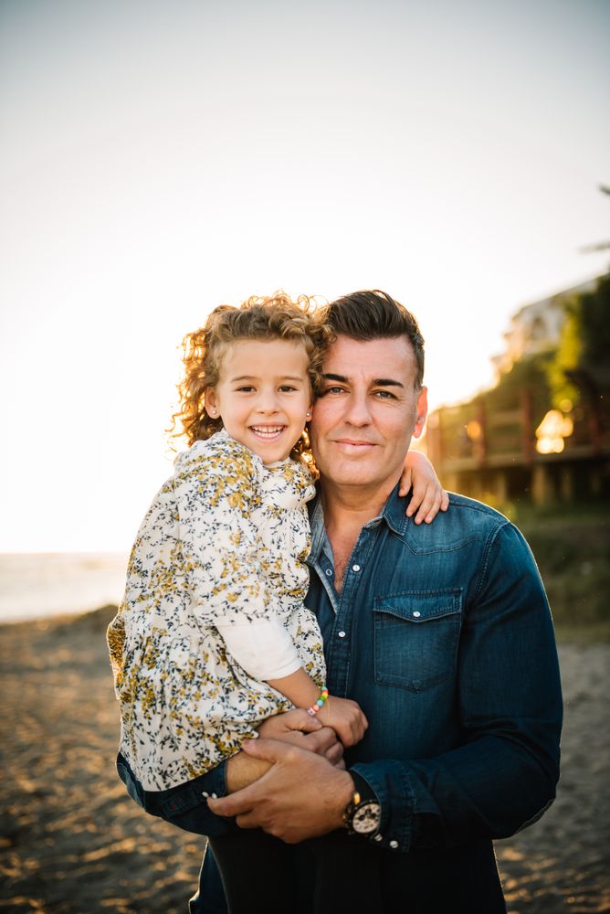 Father with her daughter at beach
