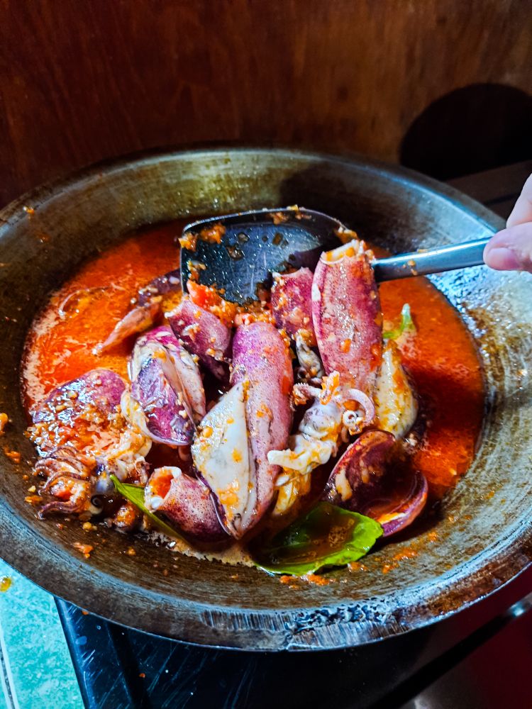 Cumi Balado or red chili squid. one of the typical Minangkabau dishes in Indonesia, fresh squid cooked with spicy chili sauce.