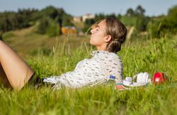 young student lying at the park in a sunny day