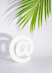 At symbol under palm leaf, vertical
