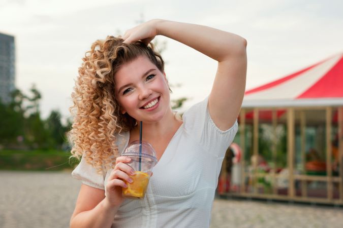 Woman with drink outdoors