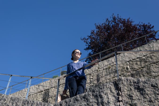 Serious businesswoman leaning on railing