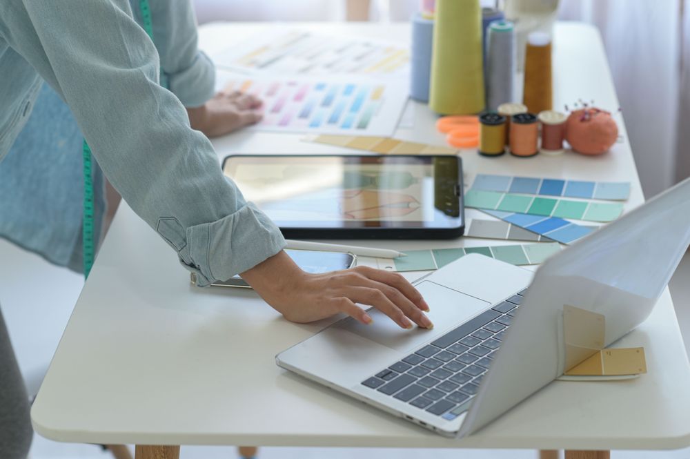 Person standing at desk with laptop