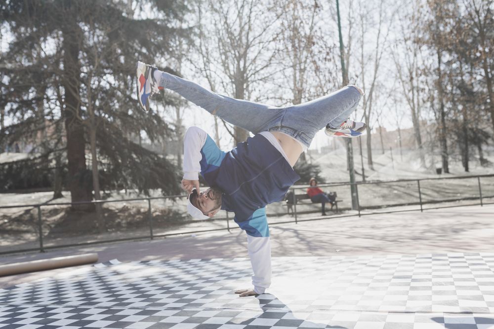 Man dancing break dance in park