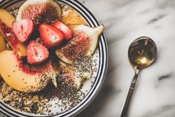 Flat-lay of yogurt bowl with fruit and spoon