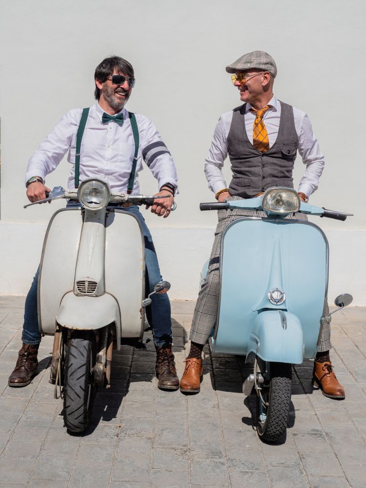 Trendy  men sitting on vintage scooters