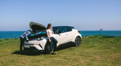 Young couple with the broken down car