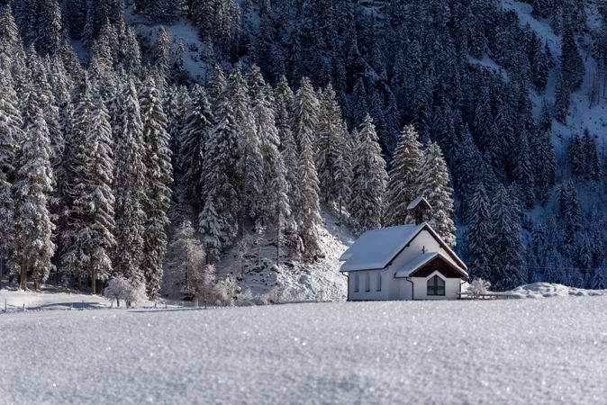 Winter landscape on a sunny day in December with a minimalist snow-covered church