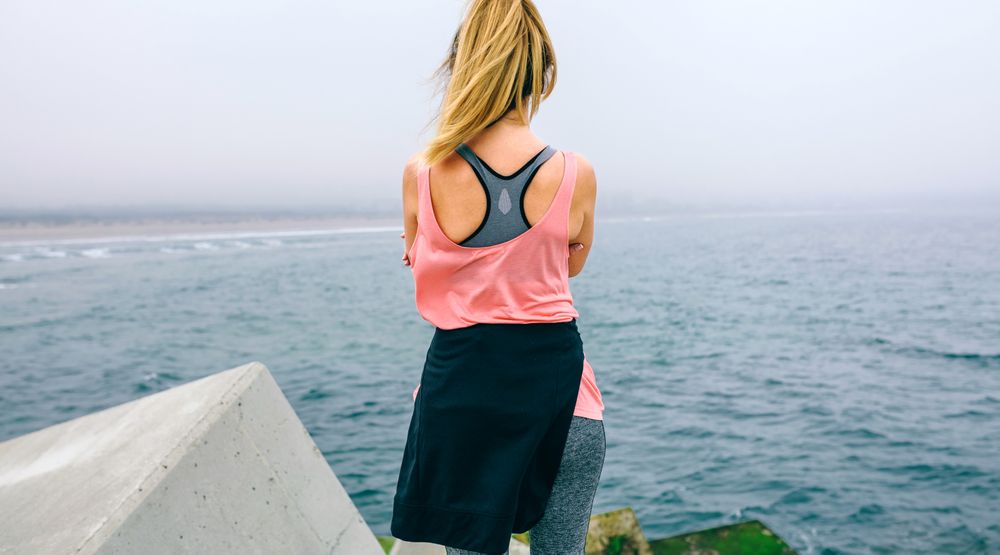 Unrecognizable young woman watching the sea