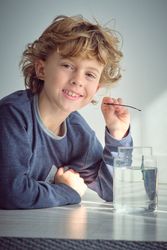 Smiling boy playing with toy fishing rod