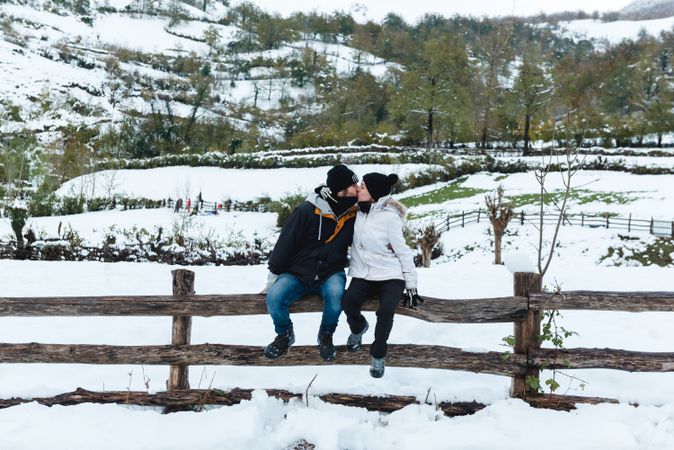 Couple kissing at winter in countryside