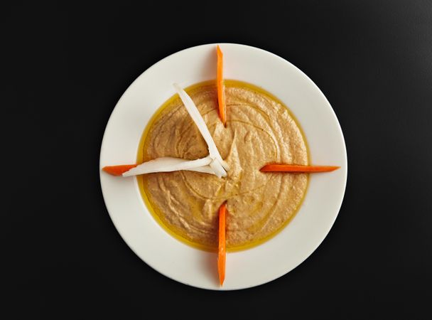 Top view of hummus and carrots