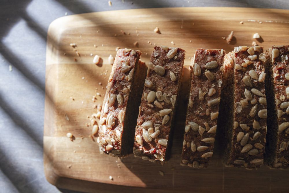 Sliced wholegrain bread on wooden cutting board