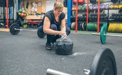 Woman applying magnesium to practice weightlifting