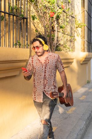 Male Musician Checking His Cell Phone