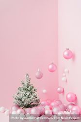 Baubles in a variety of pink shades in corner of pink room with Christmas tree 0JgBv5