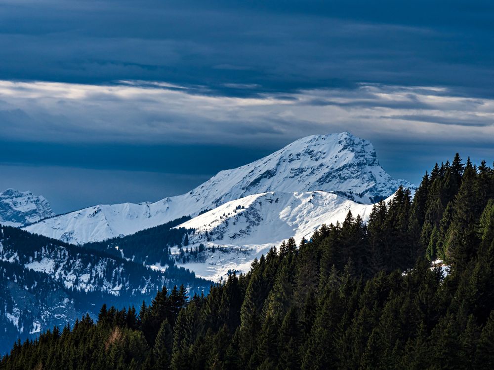 Swiss Alps winter landscape with snow and sun, mountains in Europe