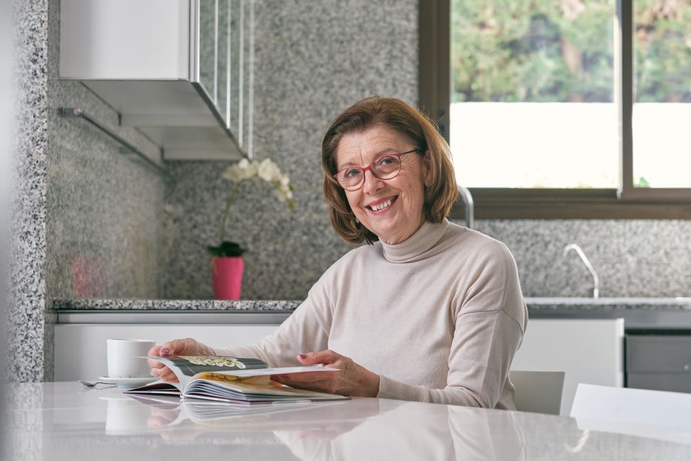 Female reading book in kitchen
