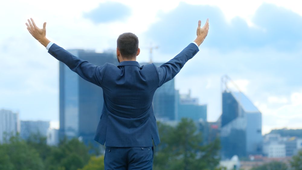 Happy Successful Business Man Raises His Hands, He Has His Business Victory.
