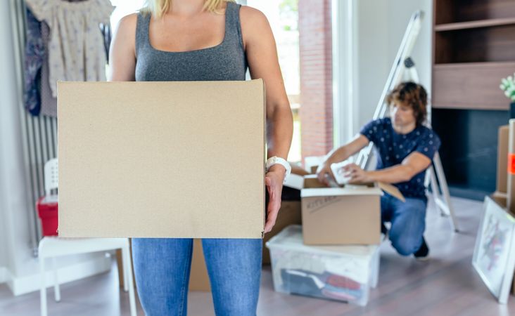 Woman carrying moving box